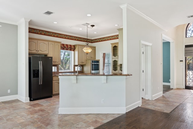 kitchen featuring stainless steel oven, refrigerator with ice dispenser, visible vents, baseboards, and stone tile flooring