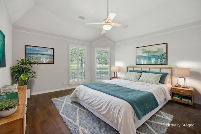 bedroom with lofted ceiling, visible vents, dark wood-type flooring, baseboards, and ceiling fan