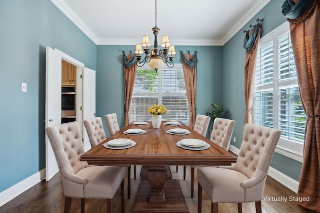 dining space with a notable chandelier, baseboards, crown molding, and wood finished floors