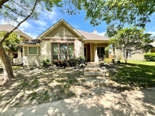 view of front facade featuring stone siding and a chimney