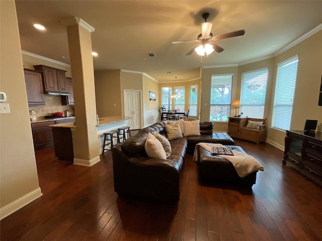 living room with baseboards, crown molding, dark wood-style floors, and ceiling fan