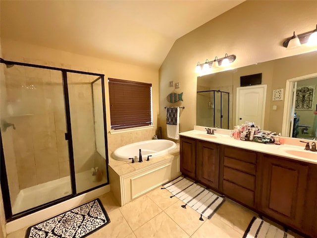 bathroom featuring vaulted ceiling, a garden tub, a stall shower, and a sink