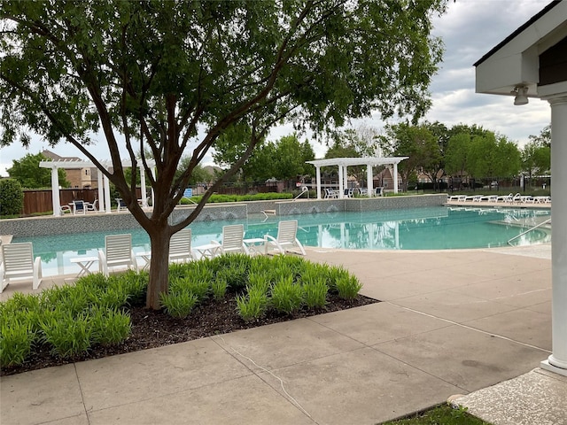 pool with a pergola and fence