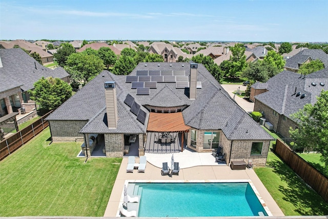 1011 Caribou Dr, Prosper, TX 75078 - rear view of house with brick siding, a fenced backyard, solar panels, and a patio