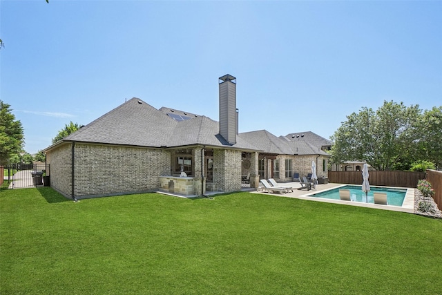 1011 Caribou Dr, Prosper, TX 75078 - back of house featuring a fenced backyard, brick siding, a patio area, and a chimney