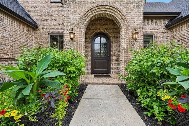 1011 Caribou Dr, Prosper, TX 75078 - property entrance featuring brick siding and roof with shingles