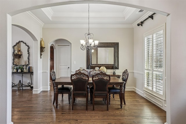 1011 Caribou Dr, Prosper, TX 75078 - dining room with a chandelier, dark wood-type flooring, arched walkways, a raised ceiling, and crown molding