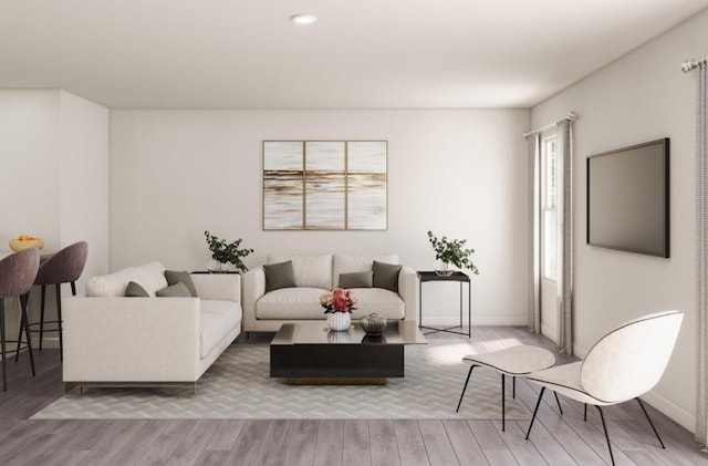 living area with baseboards, recessed lighting, and wood finished floors