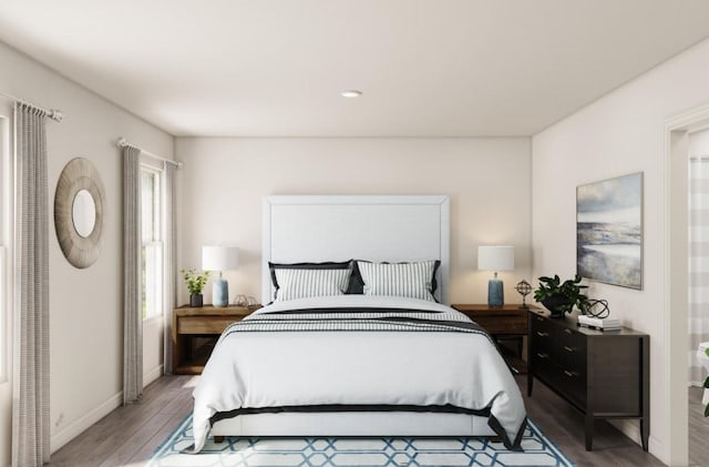 bedroom with wood finished floors and baseboards