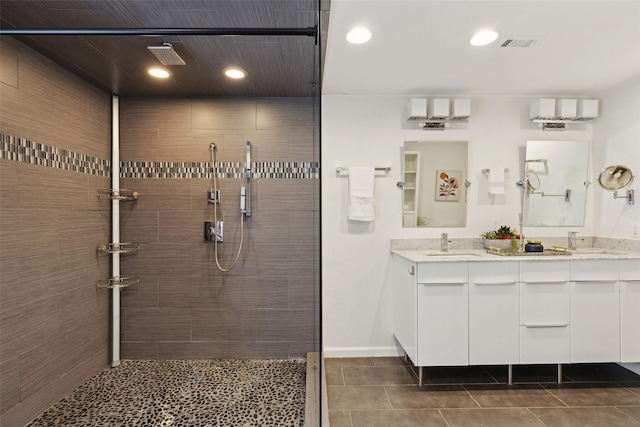 bathroom with visible vents, a sink, recessed lighting, double vanity, and tiled shower