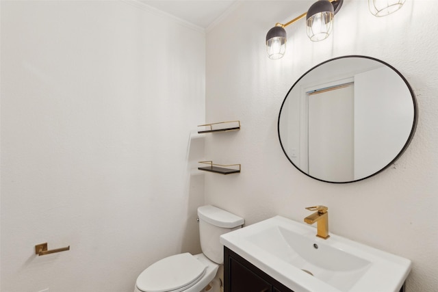 bathroom featuring ornamental molding, toilet, and vanity