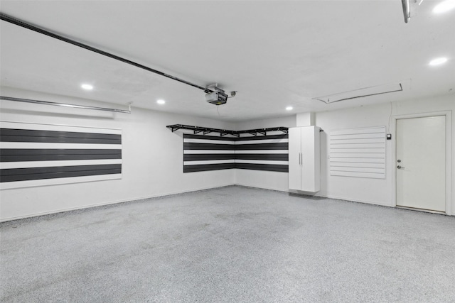 garage with a garage door opener and recessed lighting