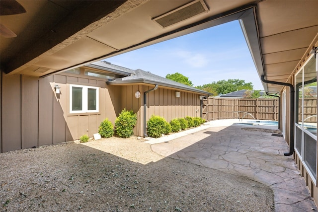 view of patio with visible vents, fence, and a fenced in pool