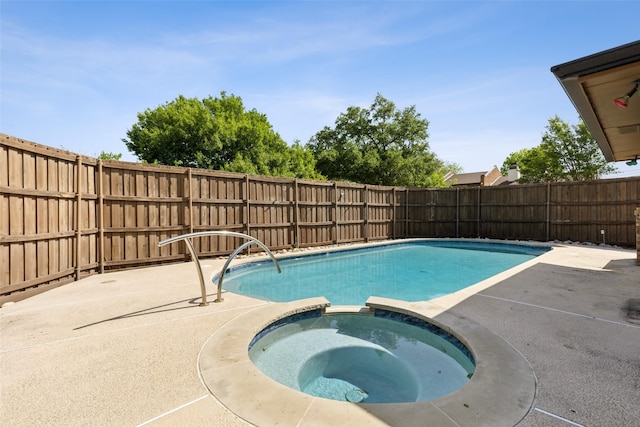view of pool with a patio, a fenced backyard, and a pool with connected hot tub