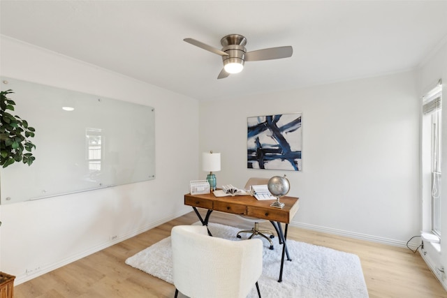 home office featuring light wood-style floors, a ceiling fan, and a wealth of natural light