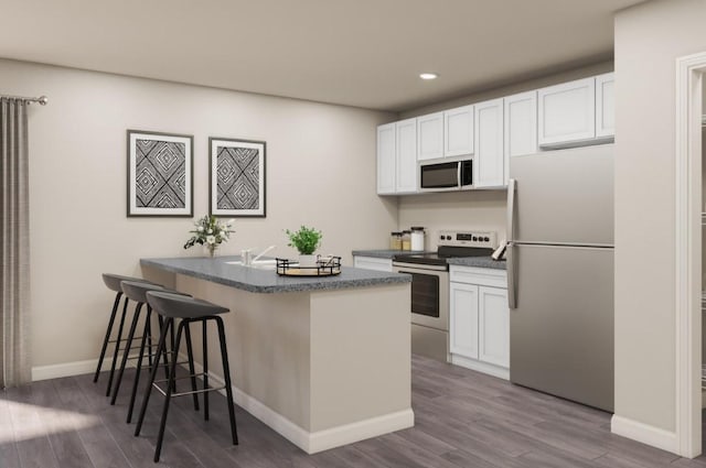 2203 Brooke Ln, Brownwood, TX 76801 - kitchen featuring dark countertops, appliances with stainless steel finishes, a breakfast bar, and dark wood finished floors
