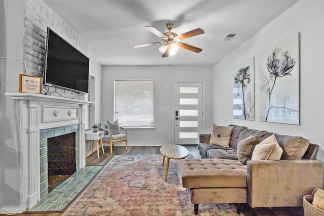 4040 Carolyn Rd, Fort Worth, TX 76109 - living room with a tile fireplace, a ceiling fan, and wood finished floors