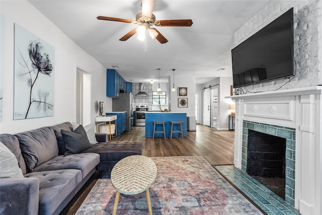 4040 Carolyn Rd, Fort Worth, TX 76109 - living area with dark wood-type flooring, a ceiling fan, and a tile fireplace
