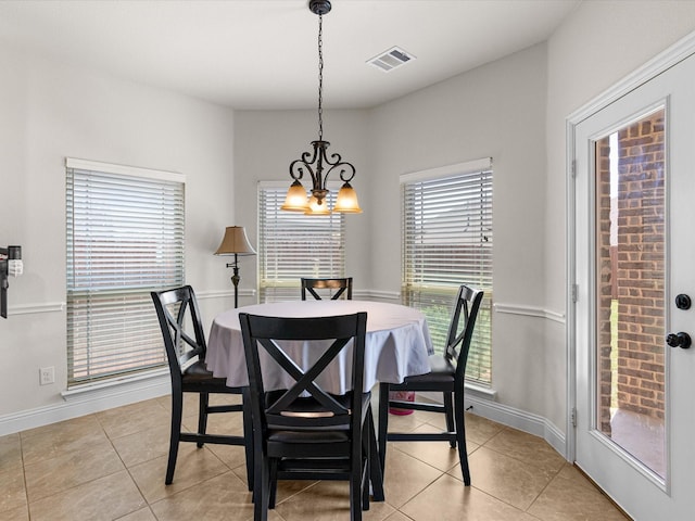 dining room featuring light tile patterned floors, baseboards, and visible vents