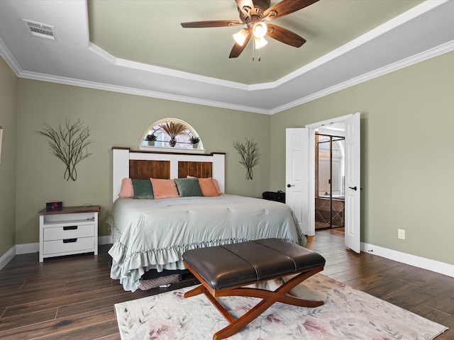 bedroom with visible vents, baseboards, ceiling fan, a tray ceiling, and wood finished floors