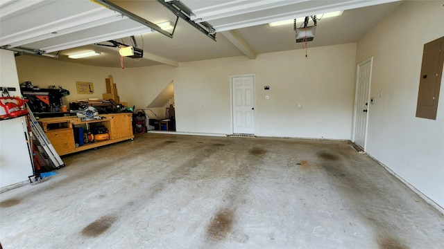 garage with electric panel, a workshop area, and a garage door opener