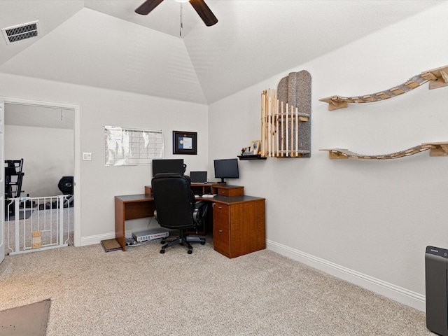 carpeted office with a ceiling fan, visible vents, attic access, lofted ceiling, and baseboards