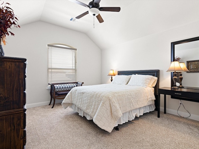 carpeted bedroom featuring visible vents, baseboards, vaulted ceiling, and ceiling fan