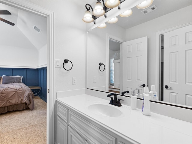 ensuite bathroom with vanity, visible vents, ceiling fan with notable chandelier, and ensuite bathroom