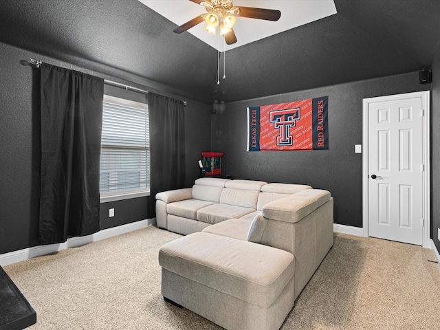 living area featuring carpet flooring, baseboards, and ceiling fan