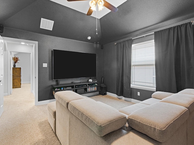 living area with carpet flooring, visible vents, baseboards, and a ceiling fan