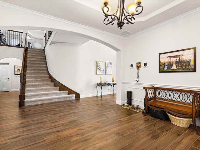 entryway featuring visible vents, arched walkways, a chandelier, stairway, and wood finished floors