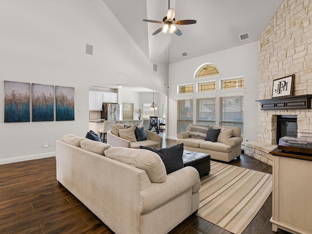 living room with dark wood finished floors, a ceiling fan, and visible vents