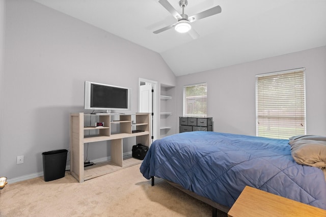 carpeted bedroom with baseboards, a ceiling fan, and vaulted ceiling