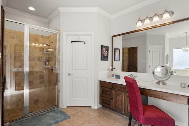 bathroom with a notable chandelier, vanity, ornamental molding, a stall shower, and tile patterned flooring