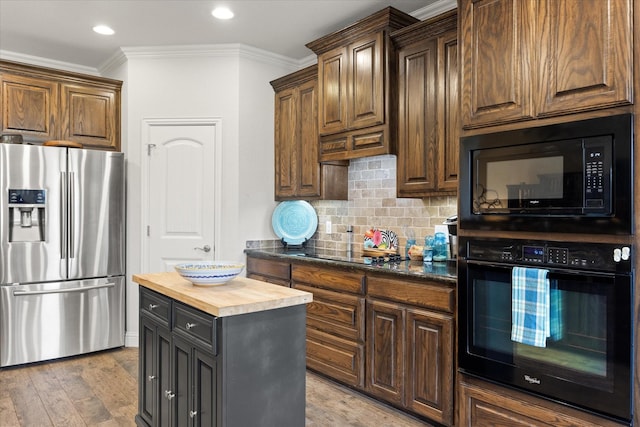 kitchen with tasteful backsplash, wooden counters, crown molding, black appliances, and light wood-style flooring
