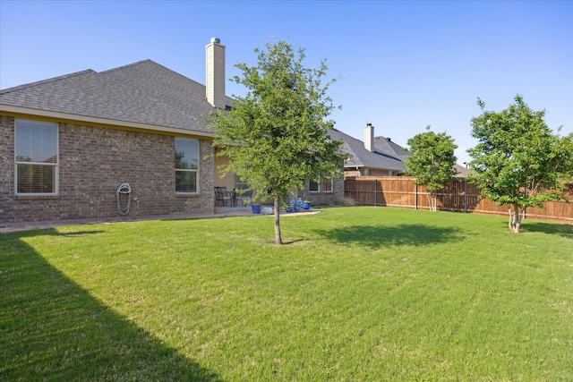 view of yard featuring a patio area and fence