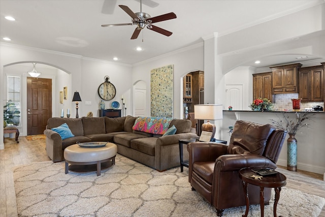 living area featuring recessed lighting, a ceiling fan, arched walkways, and wood finished floors