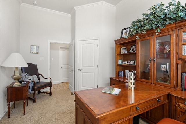 office space featuring crown molding, baseboards, and light carpet