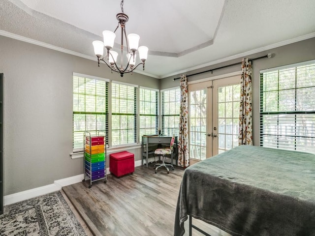 bedroom with ornamental molding, wood finished floors, access to exterior, french doors, and baseboards