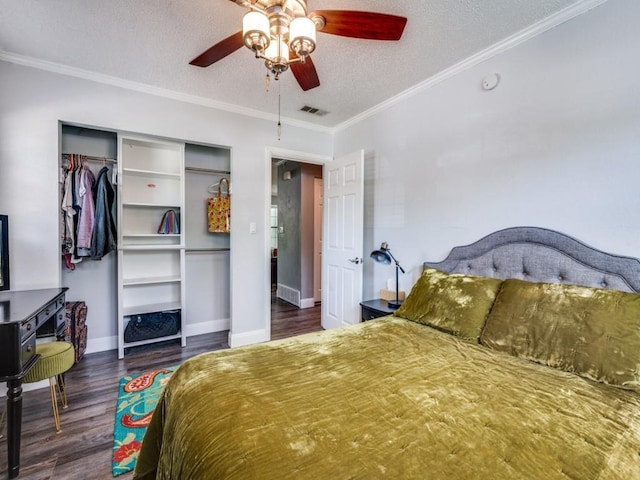 bedroom with crown molding, a textured ceiling, a closet, visible vents, and wood finished floors