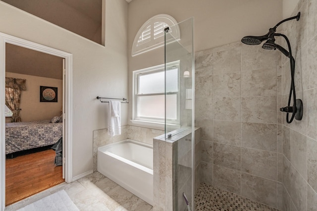 ensuite bathroom featuring a bath, ensuite bathroom, and a tile shower