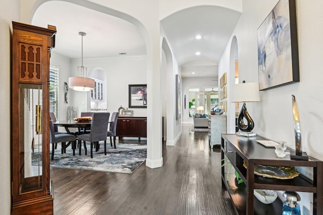 foyer featuring visible vents, dark wood-style floors, arched walkways, and recessed lighting