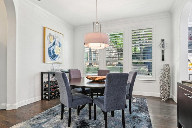 dining area featuring arched walkways, baseboards, dark wood-style floors, and ornamental molding
