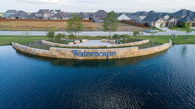 drone / aerial view with a residential view and a water view