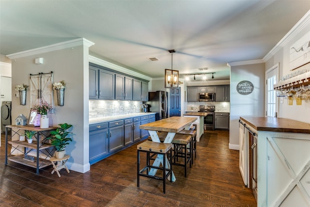 4505 Pangolin Dr, Fort Worth, TX 76244 - kitchen with wooden counters, stainless steel appliances, ornamental molding, dark wood-type flooring, and tasteful backsplash