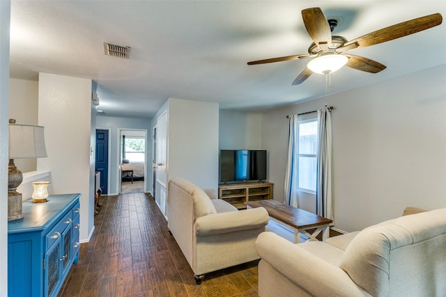 4505 Pangolin Dr, Fort Worth, TX 76244 - living area featuring baseboards, dark wood-style flooring, a ceiling fan, and a healthy amount of sunlight