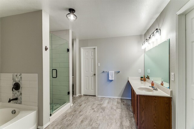 4505 Pangolin Dr, Fort Worth, TX 76244 - bathroom featuring baseboards, a garden tub, wood finished floors, and a stall shower