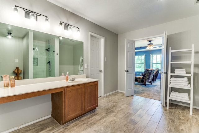 4505 Pangolin Dr, Fort Worth, TX 76244 - full bath with wood finished floors, a ceiling fan, vanity, baseboards, and a stall shower