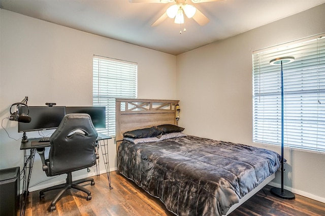 bedroom with wood finished floors, baseboards, and a ceiling fan