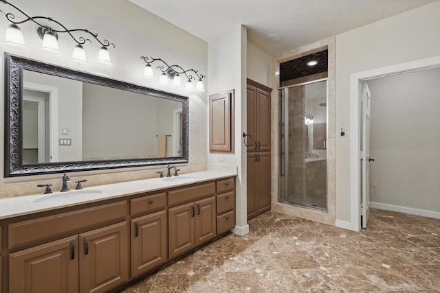 full bath with a shower stall, baseboards, and a sink